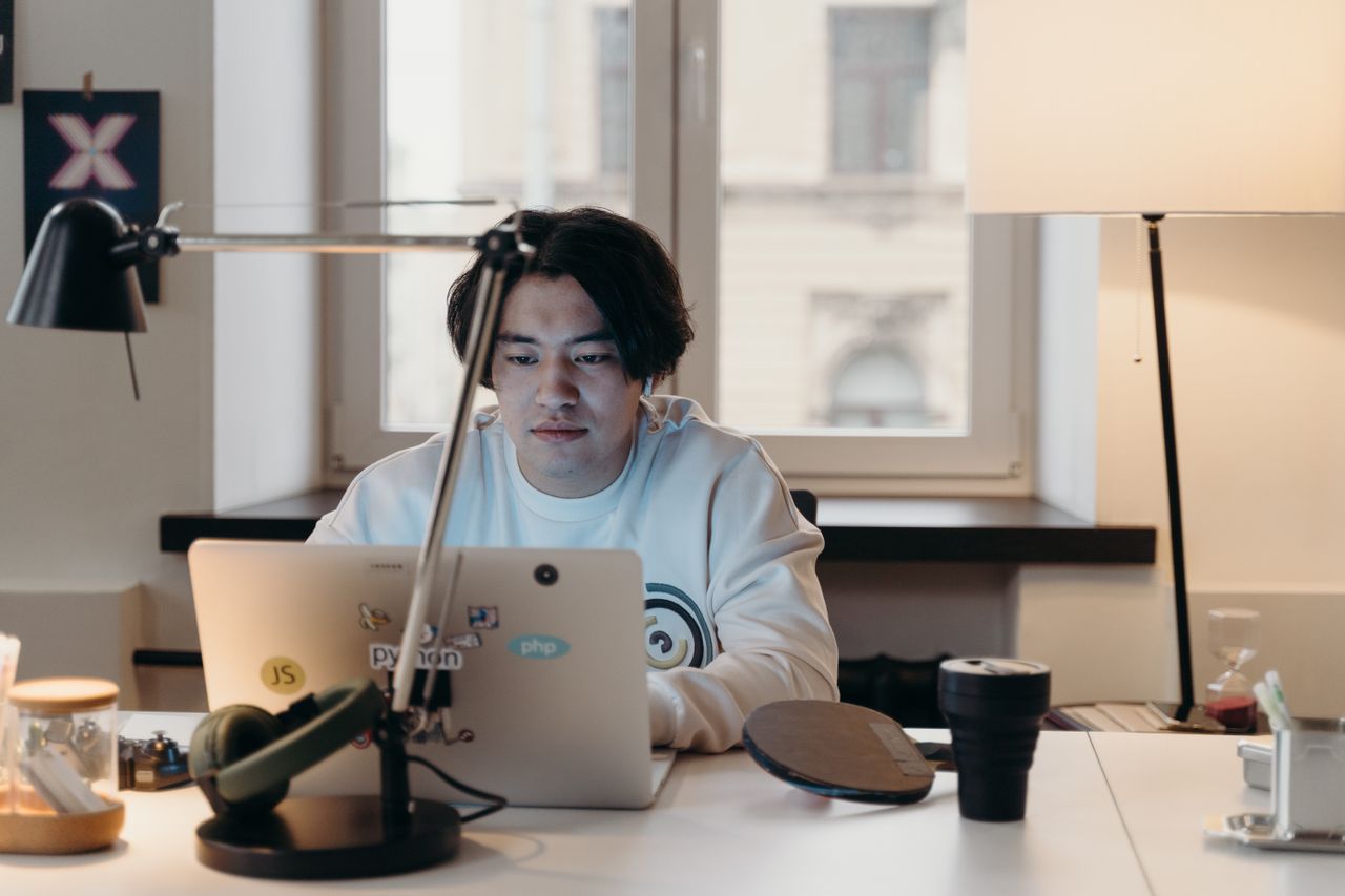The Art of Drawing Readers In: Your attractive post title goes here Focused young man working at his desk with a laptop in a contemporary office.